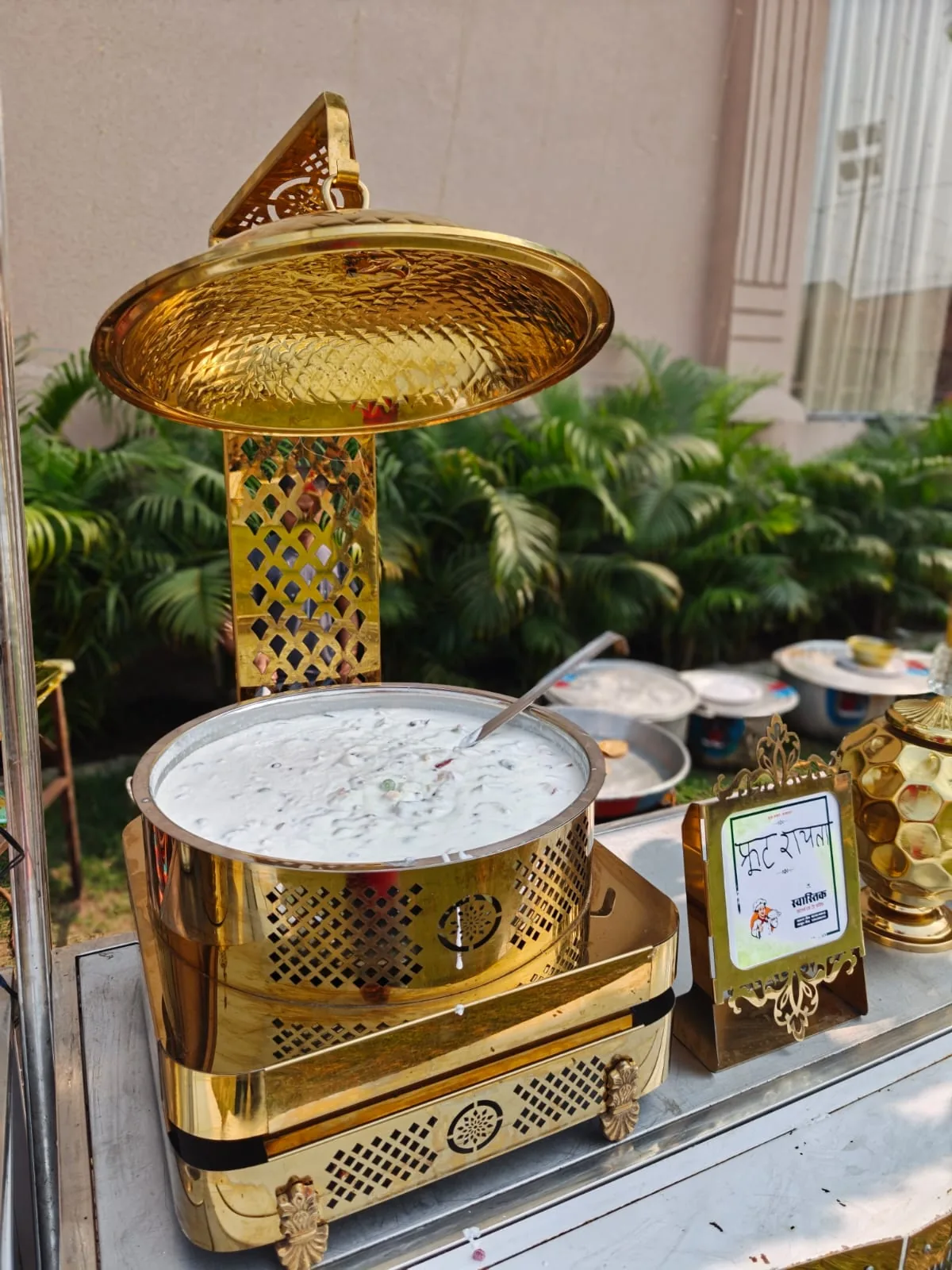 Fruit raita presented in premium golden serviceware