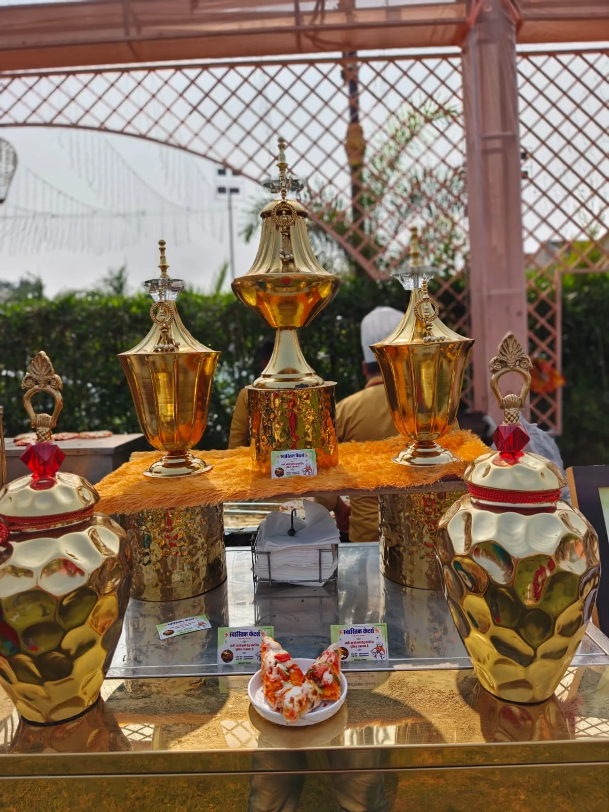 Golden decorative vessels at a premium food counter